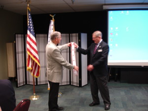 MOAA Washington State Council of Chapters (WSCOC) President, "Slots" presents CRC President, Dave Casteel, with 2013 Level of Excellence banner